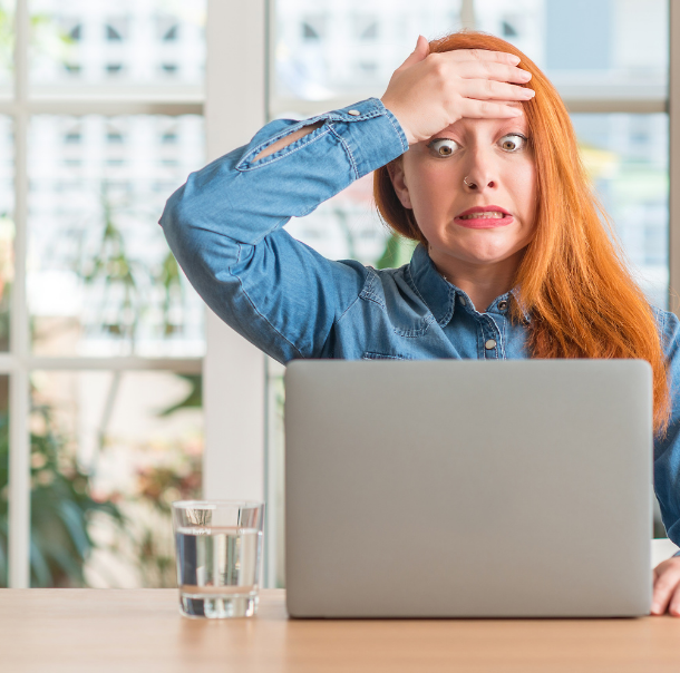 A woman putting her hand on her forehead after being shocked