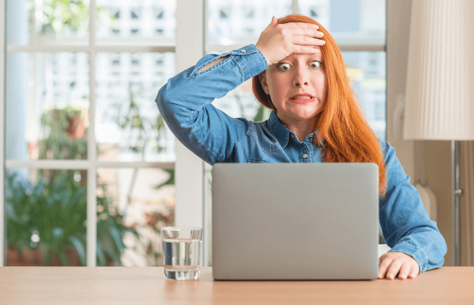 A woman putting her hand on her forehead after being shocked